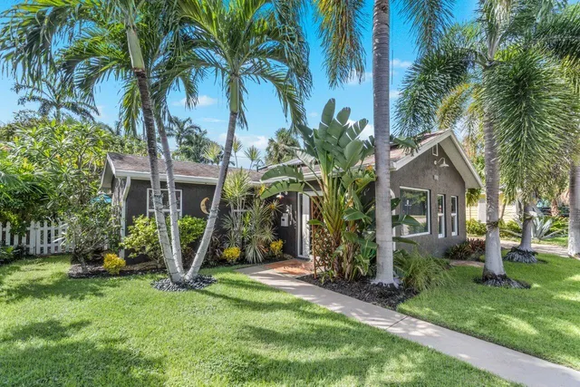 a front view of house with yard and trees