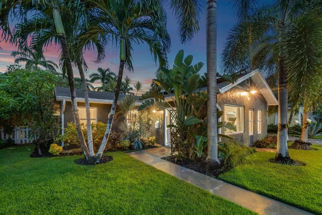 a view of a house with a flower garden