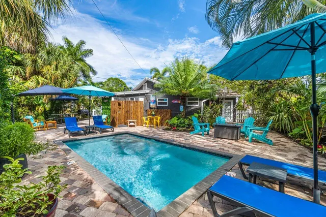 a living room with furniture kitchen and a large window