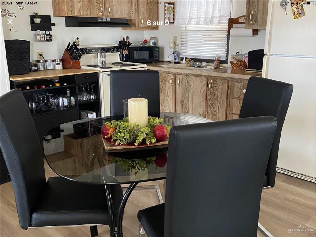 109 Ash Street Mission, TX 78572 - Photo 2 of 7 a kitchen with stainless steel appliances granite countertop a table and chairs
