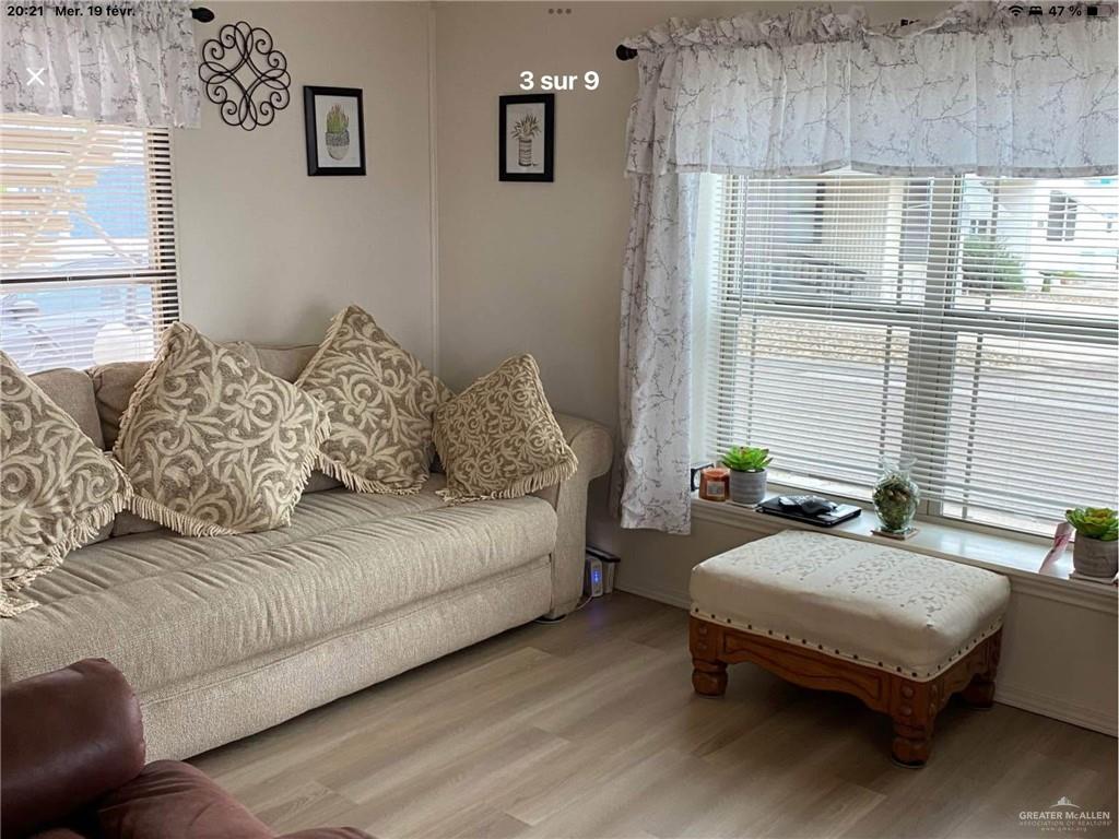 109 Ash Street Mission, TX 78572 - Photo 3 of 7 a living room with furniture and a large window