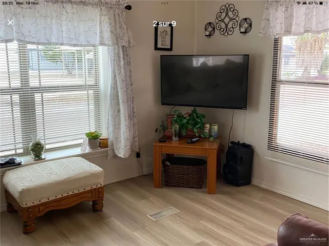 a large bed sitting in a bedroom next to a window