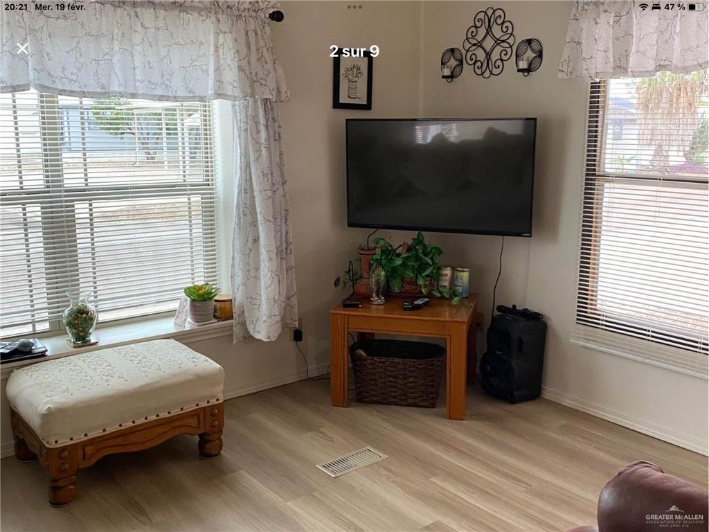 109 Ash Street Mission, TX 78572 - Photo 4 of 7 a living room with furniture a flat screen tv and a fireplace