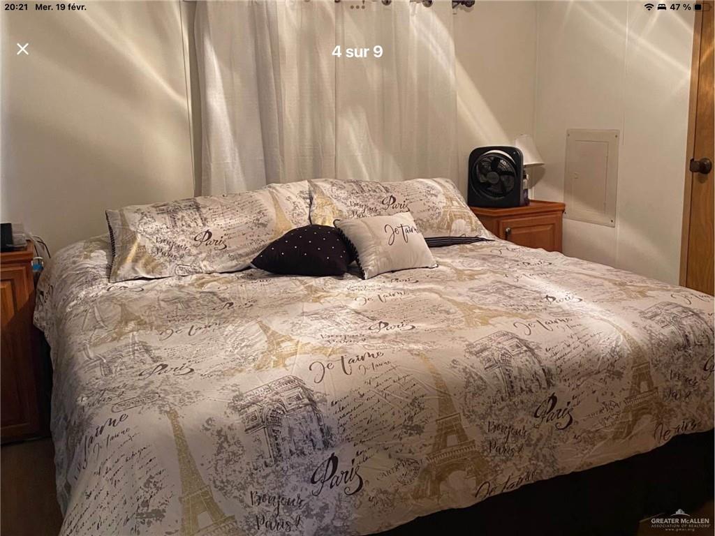 109 Ash Street Mission, TX 78572 - Photo 5 of 7 a large bed sitting in a bedroom next to a window