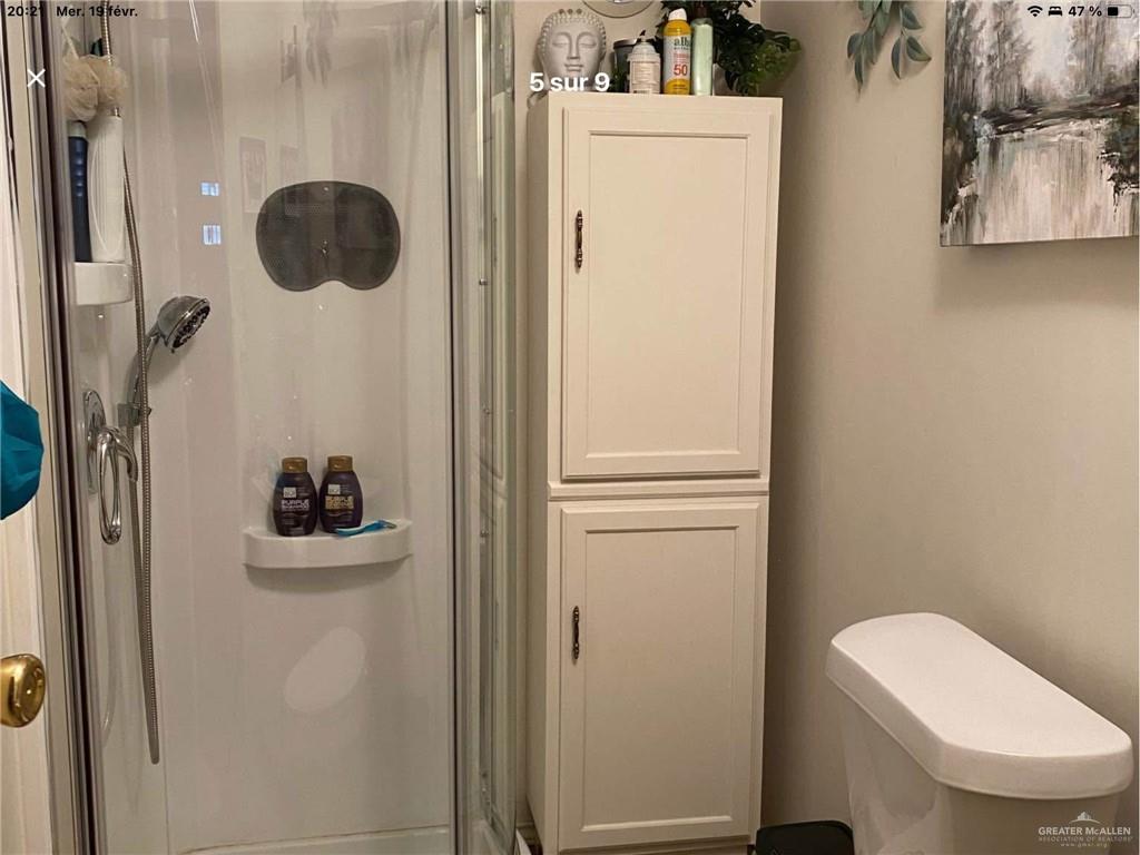 109 Ash Street Mission, TX 78572 - Photo 6 of 7 a bathroom with a toilet and a shower
