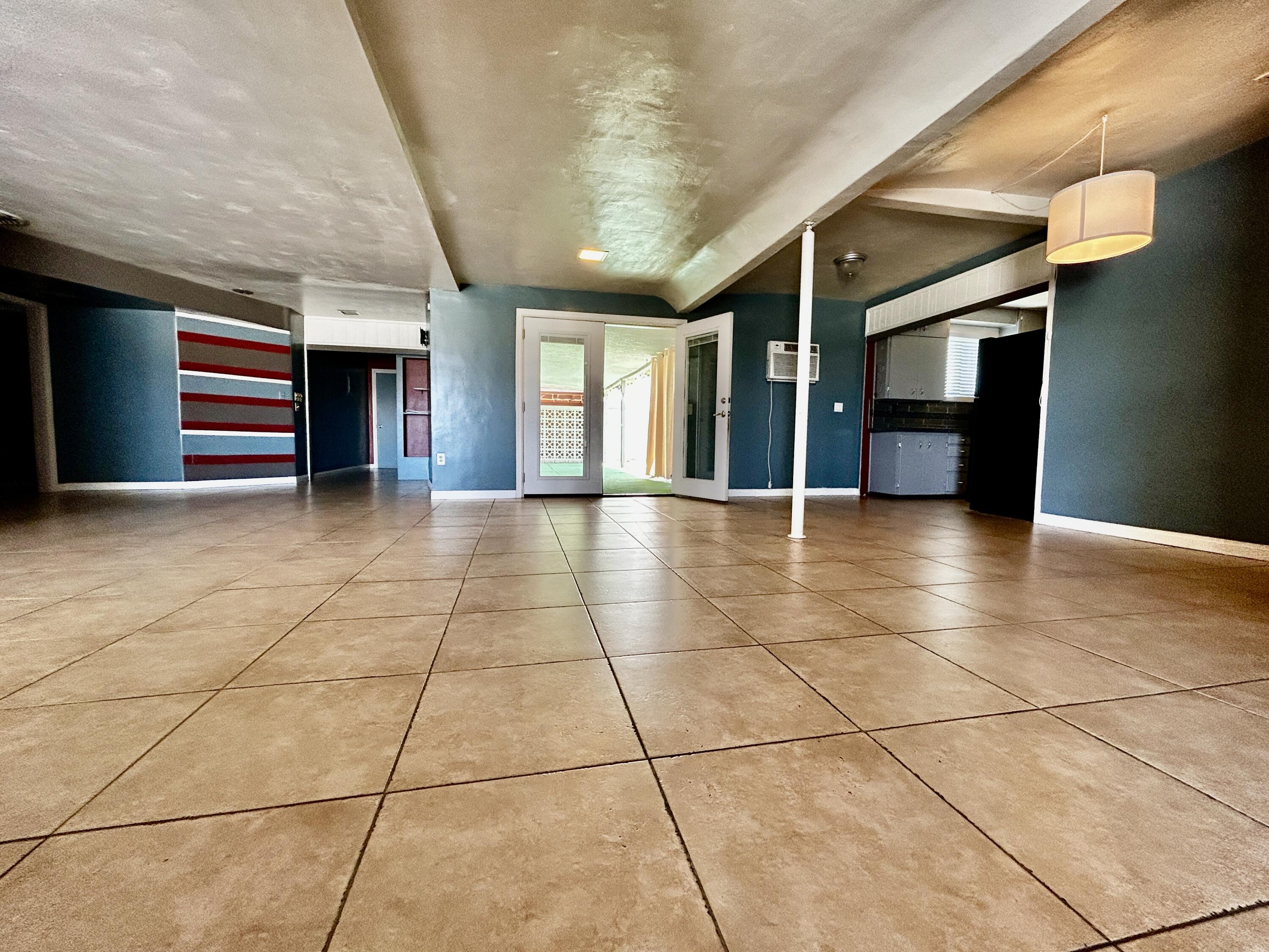 54878 Harrison Street Thermal, CA 92274 - Photo 21 of 58 a view of livingroom with an empty space and kitchen view