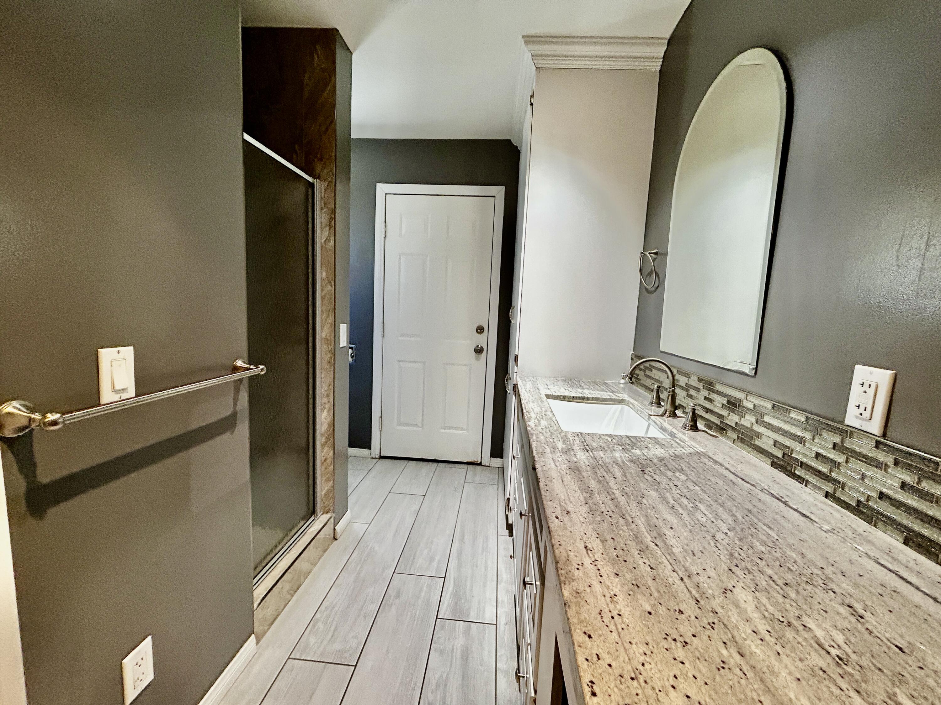 54878 Harrison Street Thermal, CA 92274 - Photo 23 of 58 a spacious bathroom with a double vanity sink and a mirror