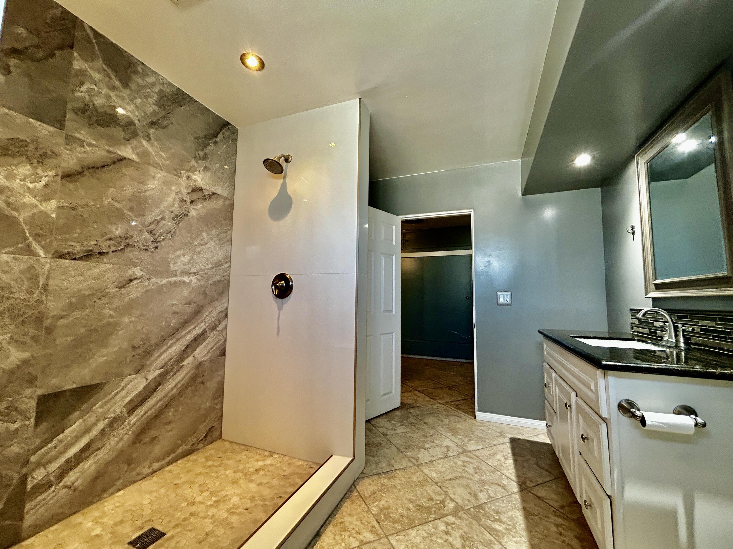 54878 Harrison Street Thermal, CA 92274 - Photo 27 of 58 a bathroom with double vanity and a shower