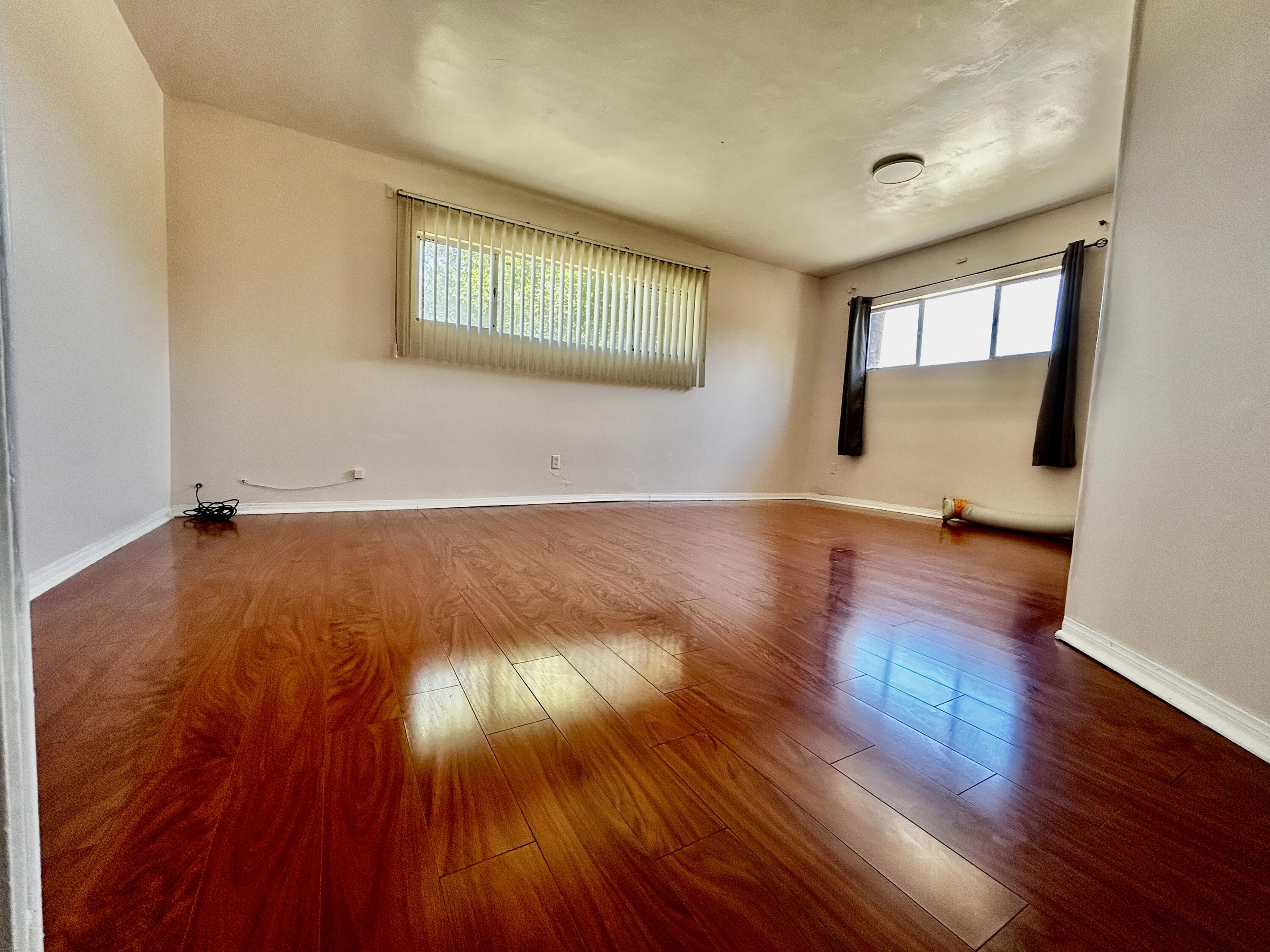 54878 Harrison Street Thermal, CA 92274 - Photo 30 of 58 an empty room with wooden floor and windows