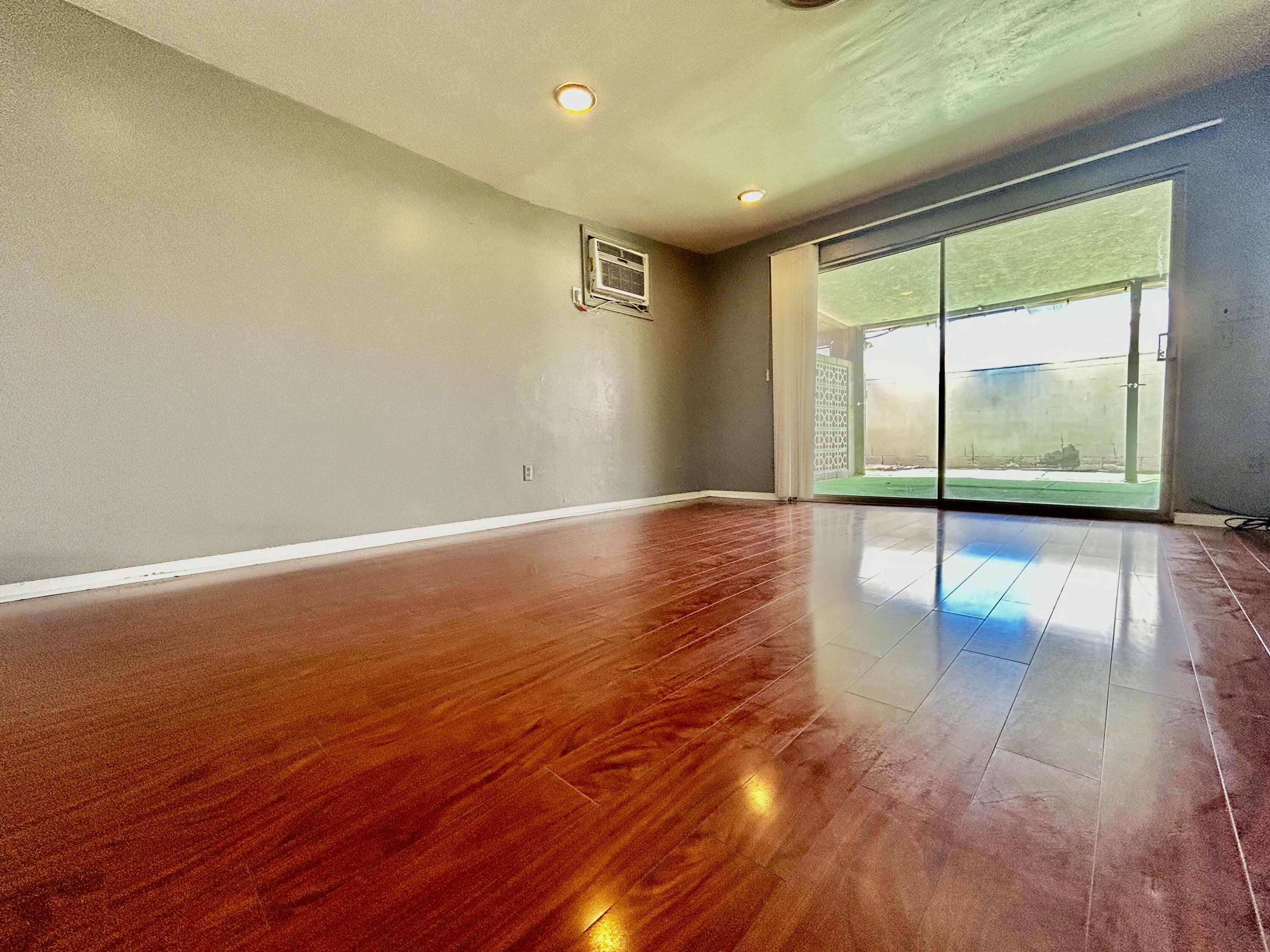 54878 Harrison Street Thermal, CA 92274 - Photo 31 of 58 a view of an empty room with wooden floor and a window