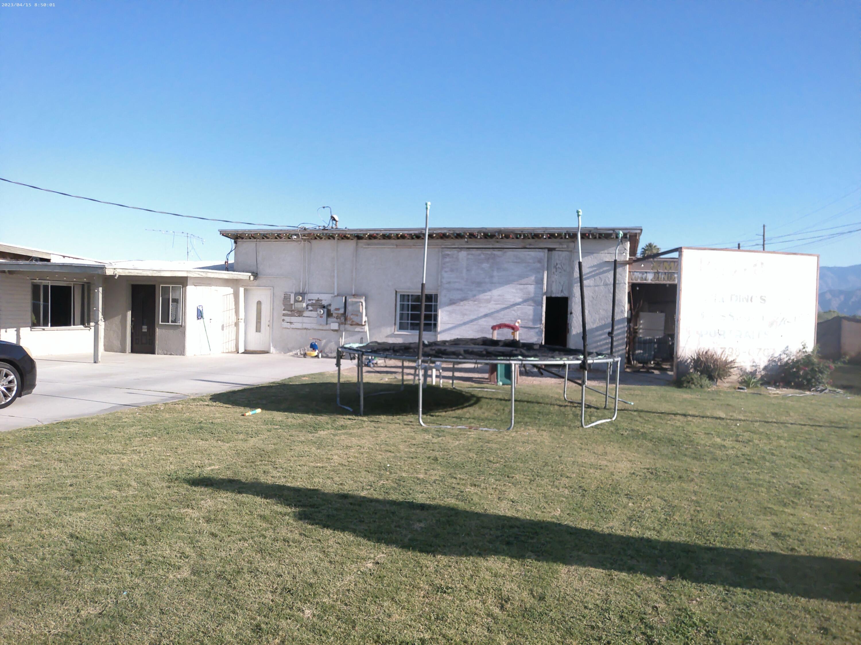 54878 Harrison Street Thermal, CA 92274 - Photo 38 of 58 a swimming pool with outdoor seating and yard