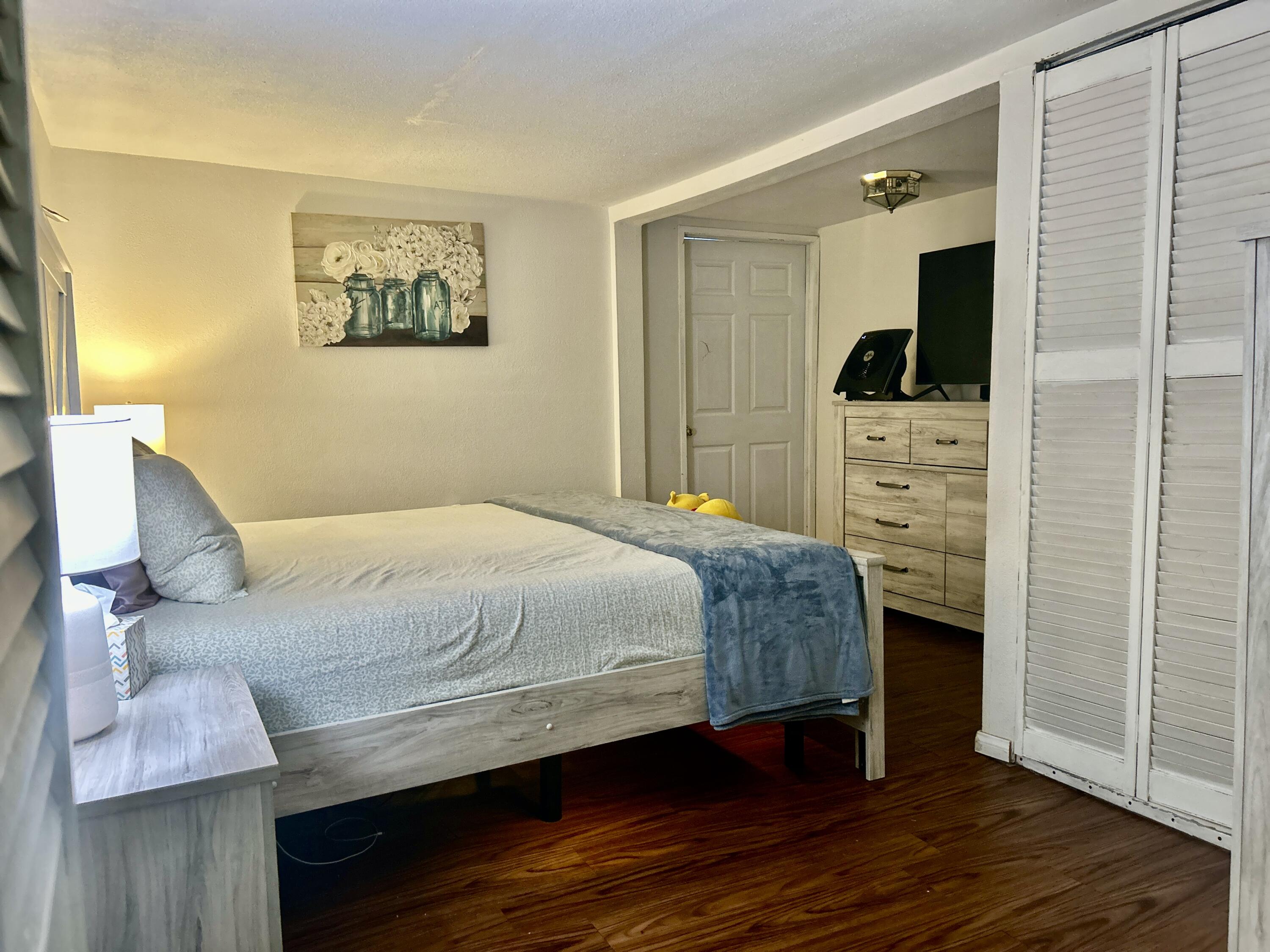 54878 Harrison Street Thermal, CA 92274 - Photo 47 of 58 a bedroom with a bed a mirror and desk