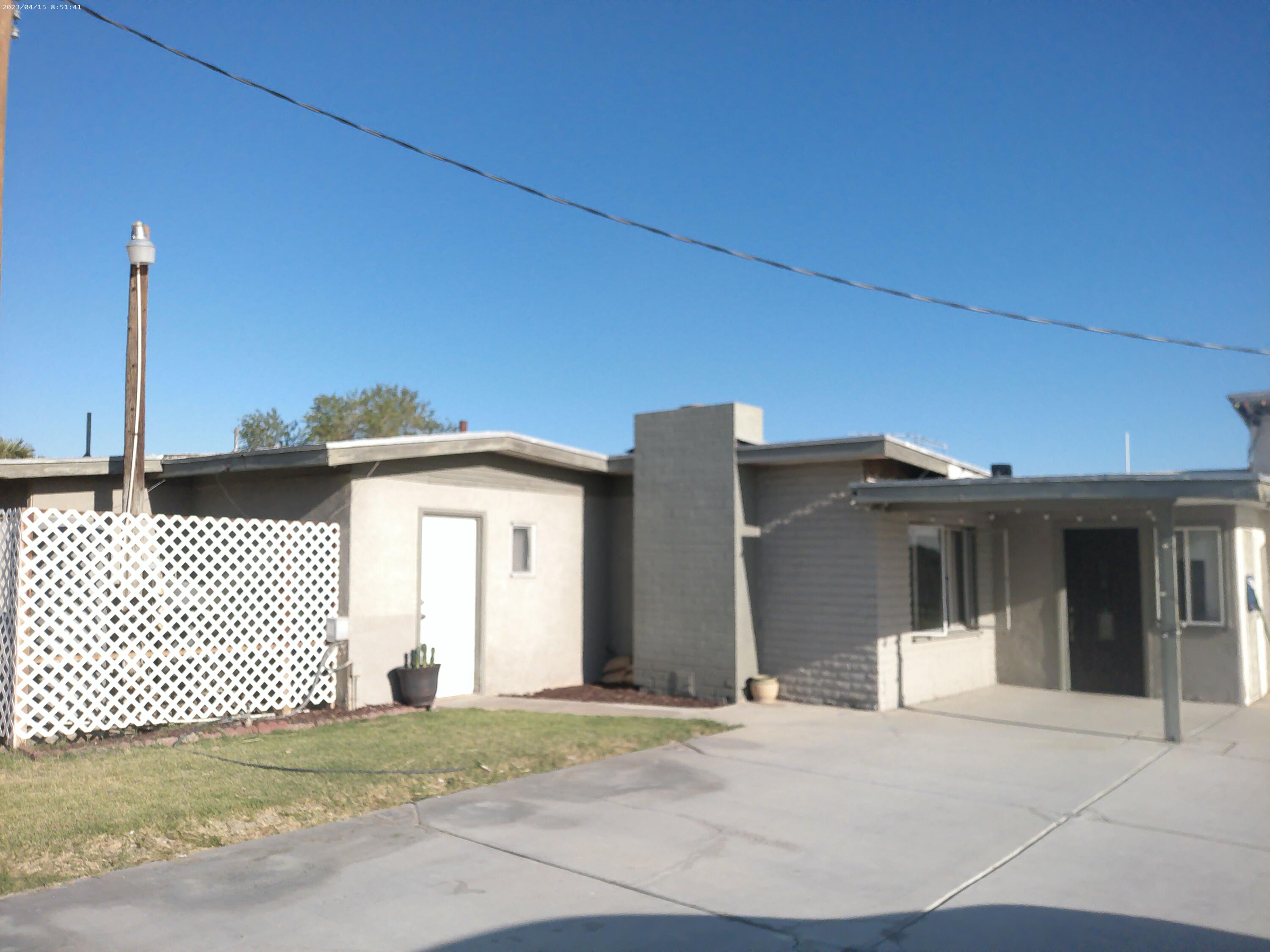54878 Harrison Street Thermal, CA 92274 - Photo 5 of 58 a front view of a house with a garage