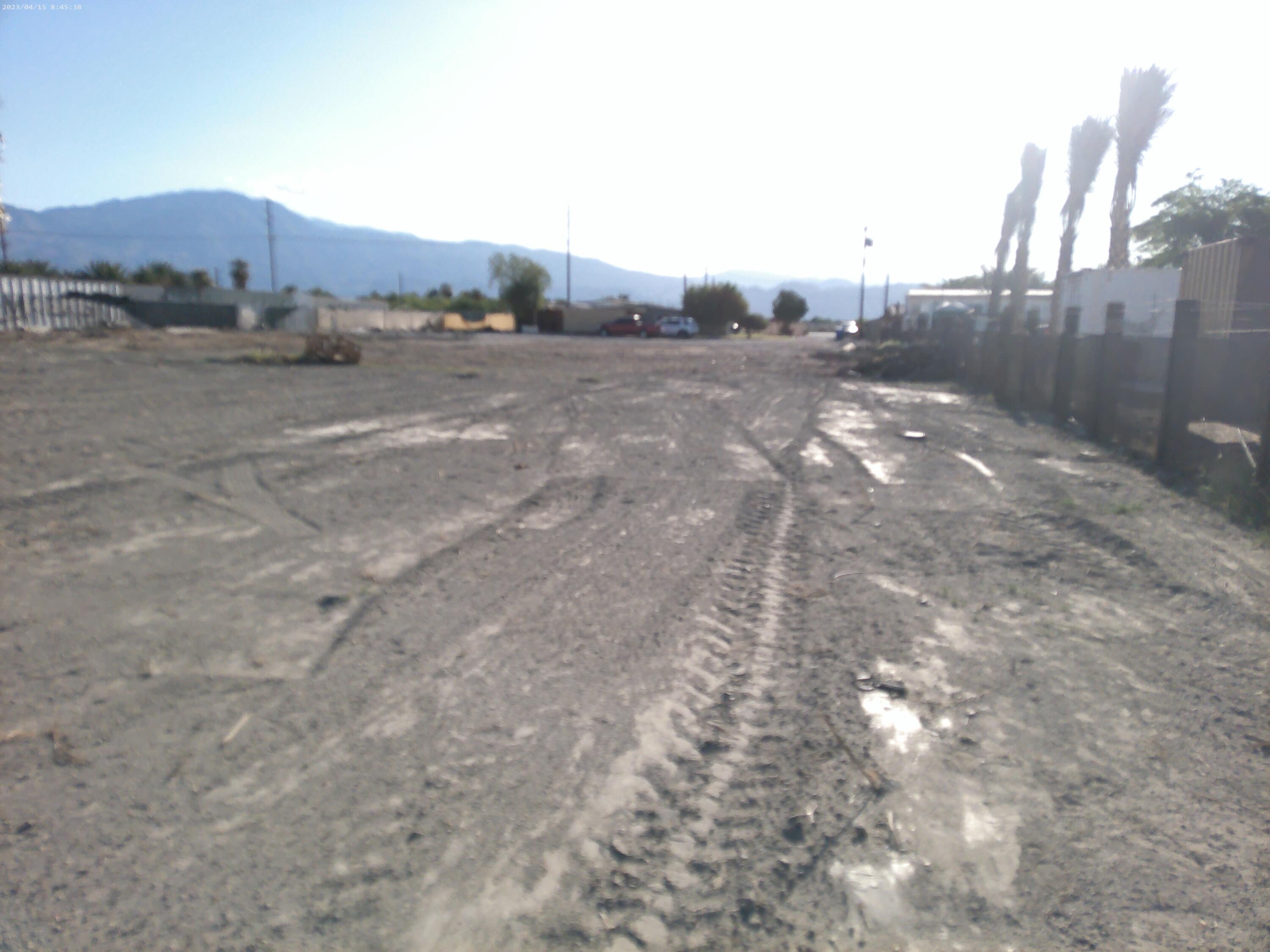 54878 Harrison Street Thermal, CA 92274 - Photo 9 of 58 a view of a road with a building in the background