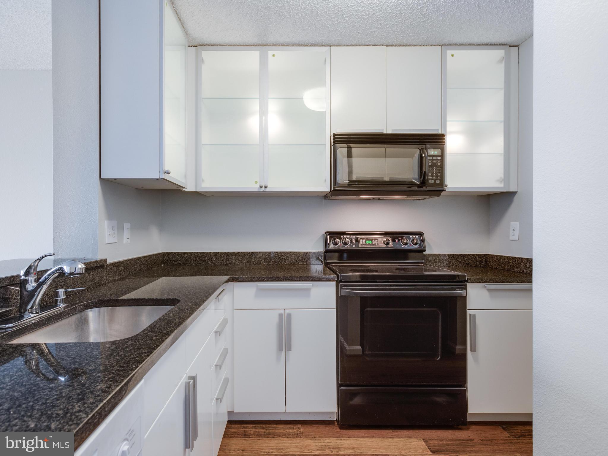 6101 Edsall Road, Unit 809 Alexandria, VA 22304 - Photo 9 of 27 UPDATED BLACK AND WHITE KITCHEN