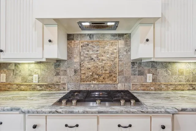 a kitchen with granite countertop a sink a stove and granite counter tops