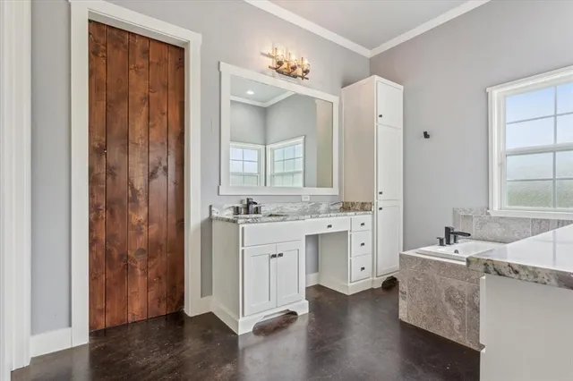 a bathroom with a double vanity sink a mirror and a bathtub