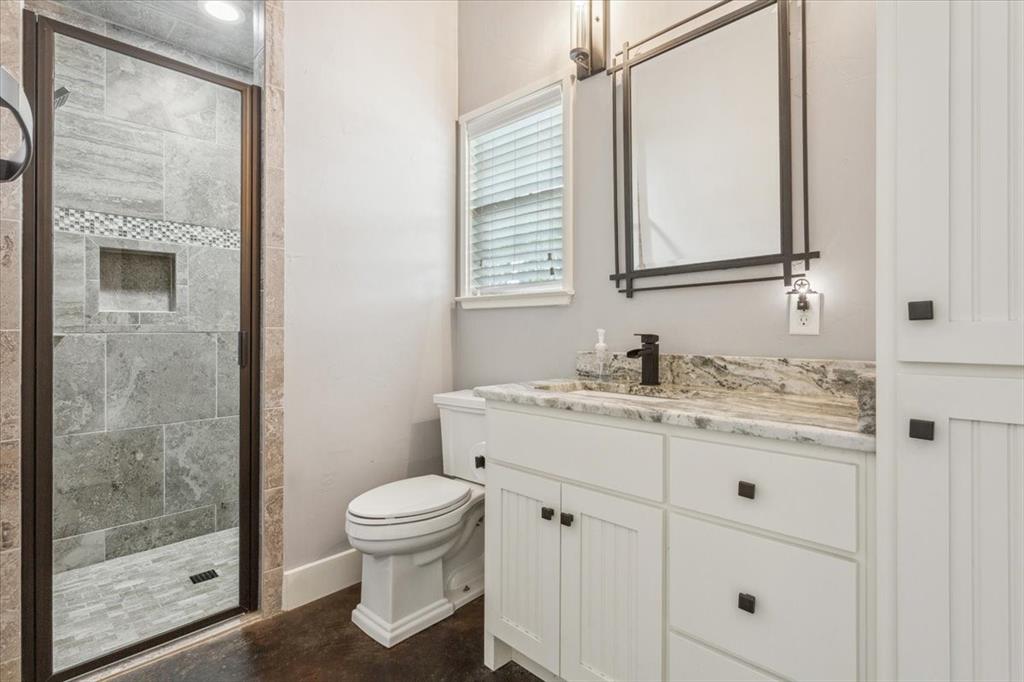 259 County Road 149 Riesel, TX 76682 - Photo 24 of 40 a bathroom with a granite countertop sink a toilet and a mirror