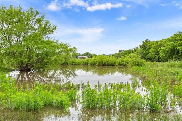 a view of a lake with houses in the back