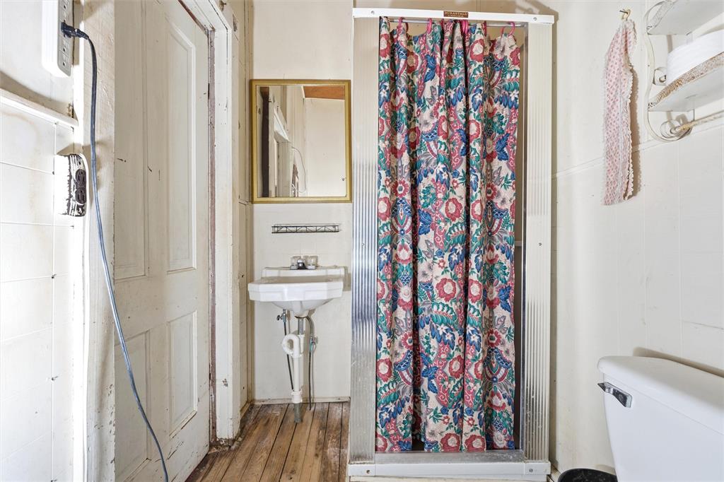 409 China Street Calvert, TX 77837 - Photo 11 of 18 a view of a bathroom with a sink and a shower curtain