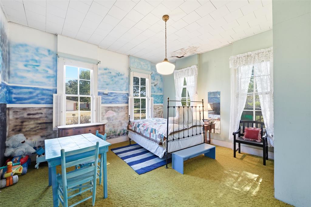 409 China Street Calvert, TX 77837 - Photo 4 of 18 a bedroom with furniture and a chandelier