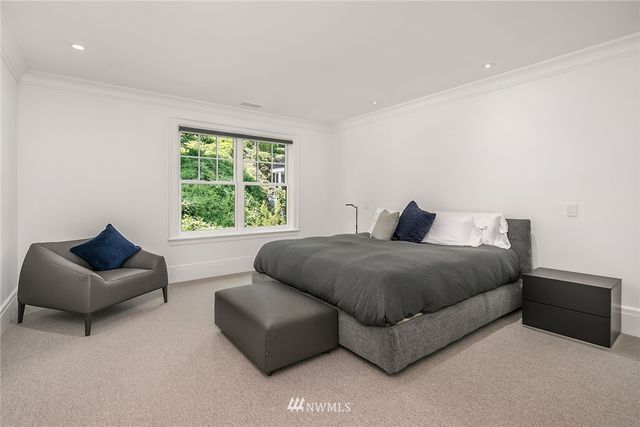 a spacious bedroom with a bed and a couch