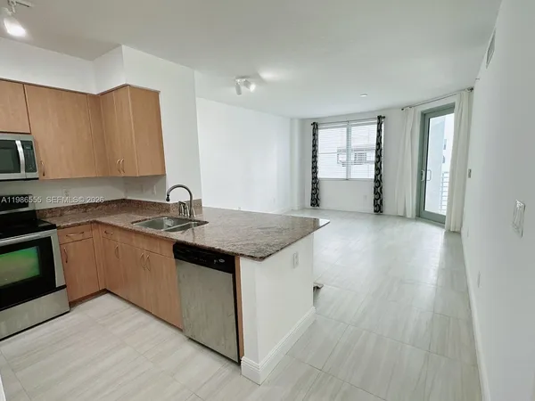 a bathroom with a granite countertop sink mirror and shower