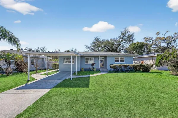 a view of a house with a backyard