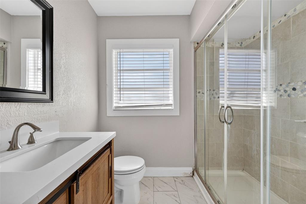 2714 West Grace Street Tampa, FL 33607 - Photo 17 of 26 a bathroom with a sink a toilet and shower