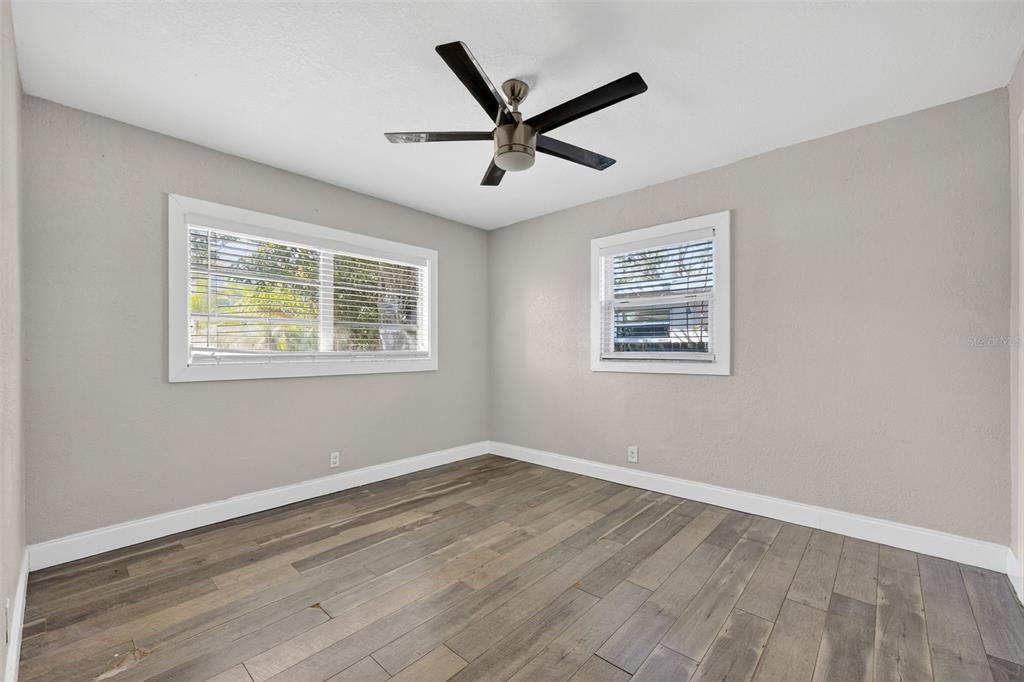 2714 West Grace Street Tampa, FL 33607 - Photo 18 of 26 a view of wooden floor and a chandelier fan in a room