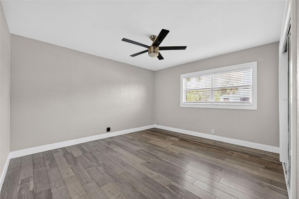 2714 West Grace Street Tampa, FL 33607 - Photo 20 of 26 a view of empty room with wooden floor and fan