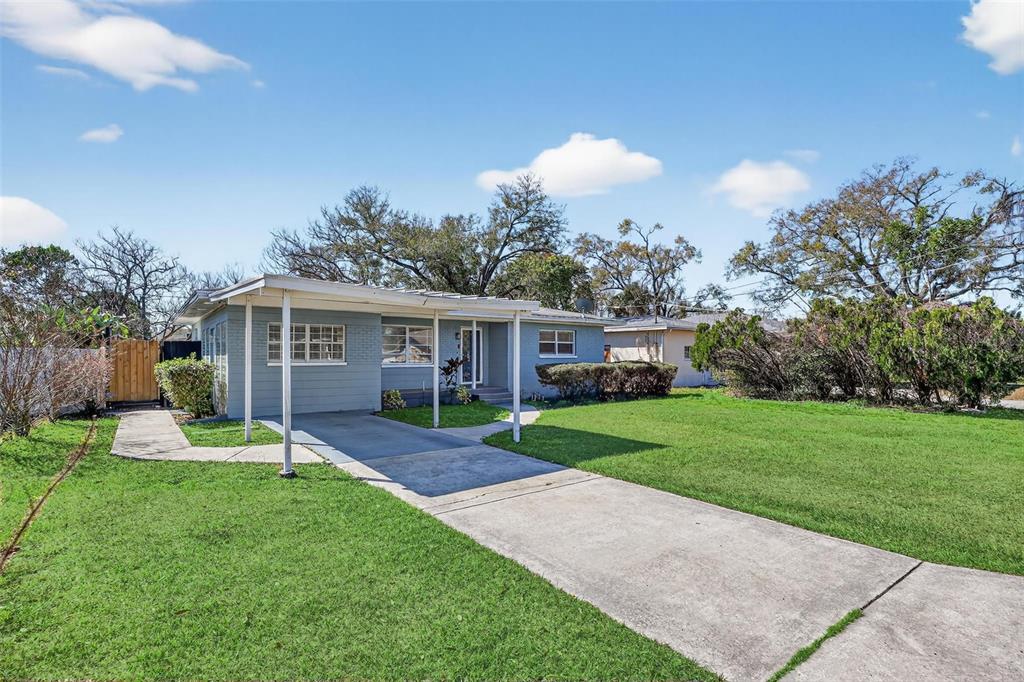 2714 West Grace Street Tampa, FL 33607 - Photo 2 of 26 a view of a house with a yard and tree s