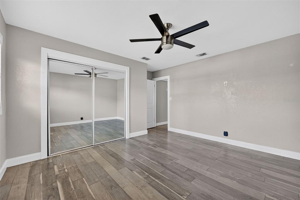 2714 West Grace Street Tampa, FL 33607 - Photo 21 of 26 a view of a livingroom with wooden floor and white walls