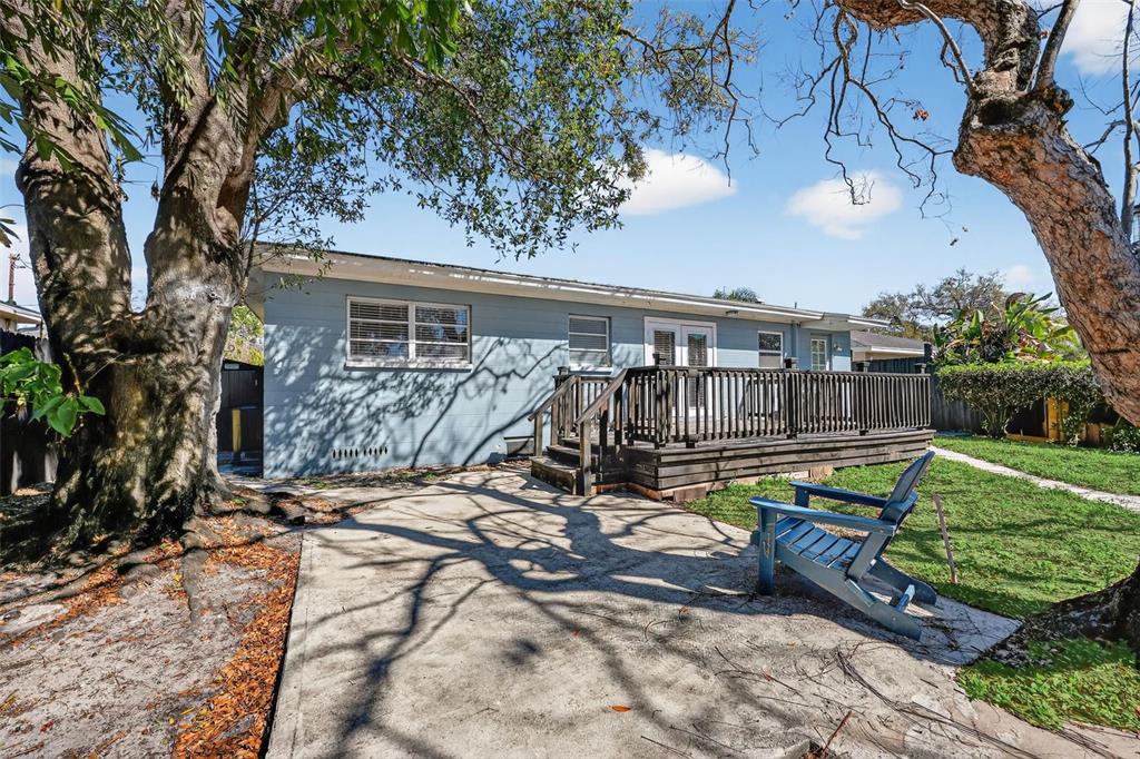 2714 West Grace Street Tampa, FL 33607 - Photo 24 of 26 a view of a house with backyard wooden fence and a large tree