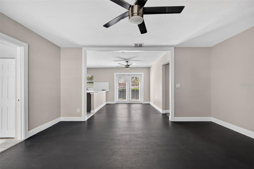 2714 West Grace Street Tampa, FL 33607 - Photo 8 of 26 a view of an empty room with window and wooden floor