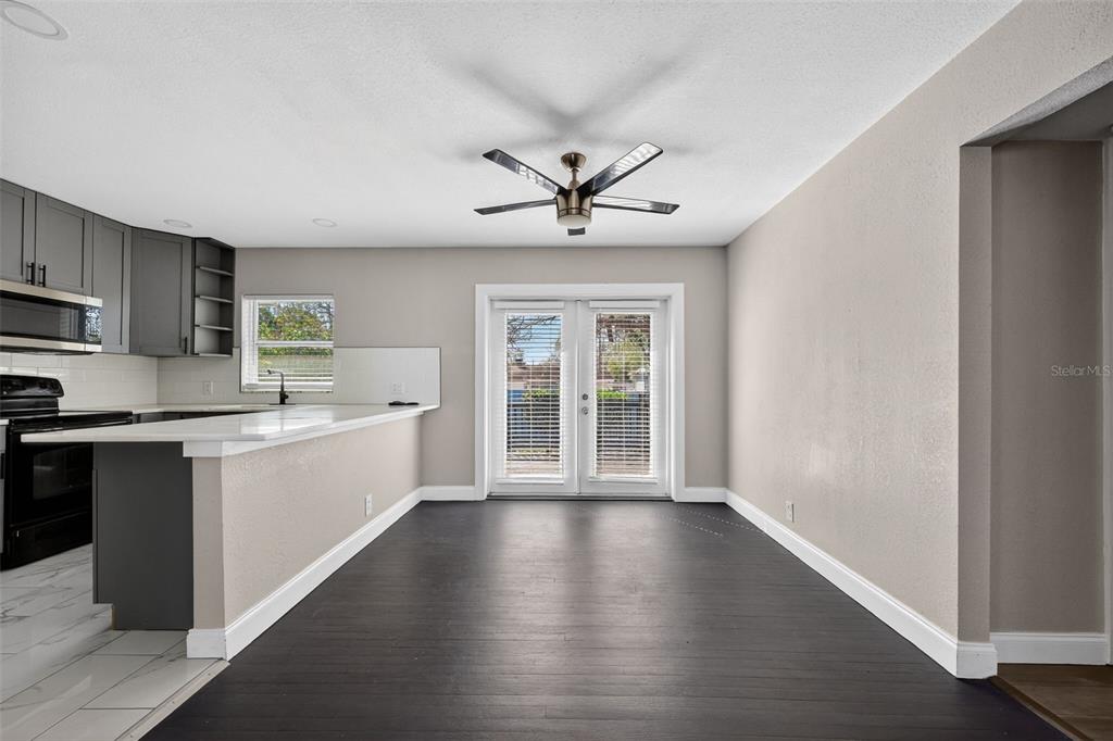 2714 West Grace Street Tampa, FL 33607 - Photo 9 of 26 a kitchen with stainless steel appliances hardwood floor sink stove and wooden cabinets