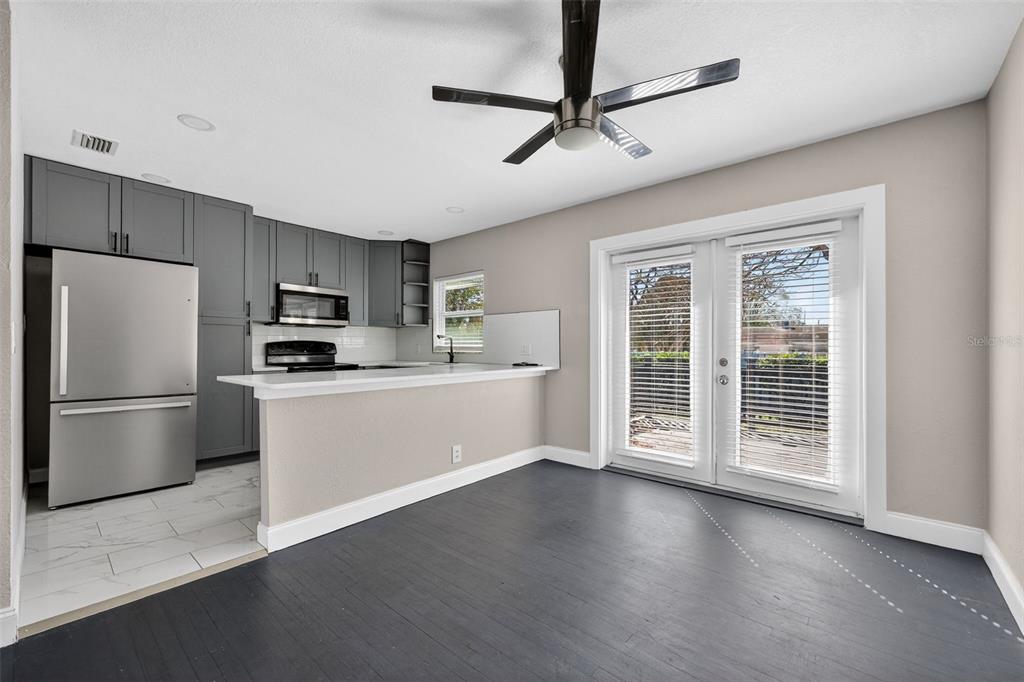 2714 West Grace Street Tampa, FL 33607 - Photo 10 of 26 a kitchen with stainless steel appliances granite countertop a refrigerator a stove a sink dishwasher a microwave oven with cabinets and wooden floor