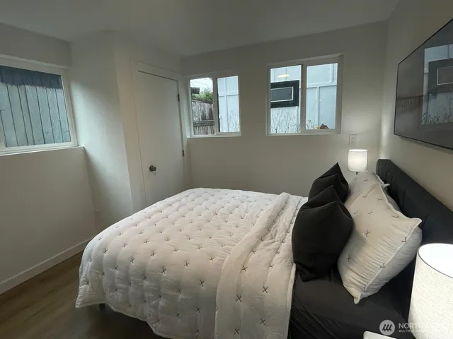 a bedroom with a bed and wooden floor