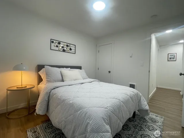a bed sitting in a bedroom next to a lamp