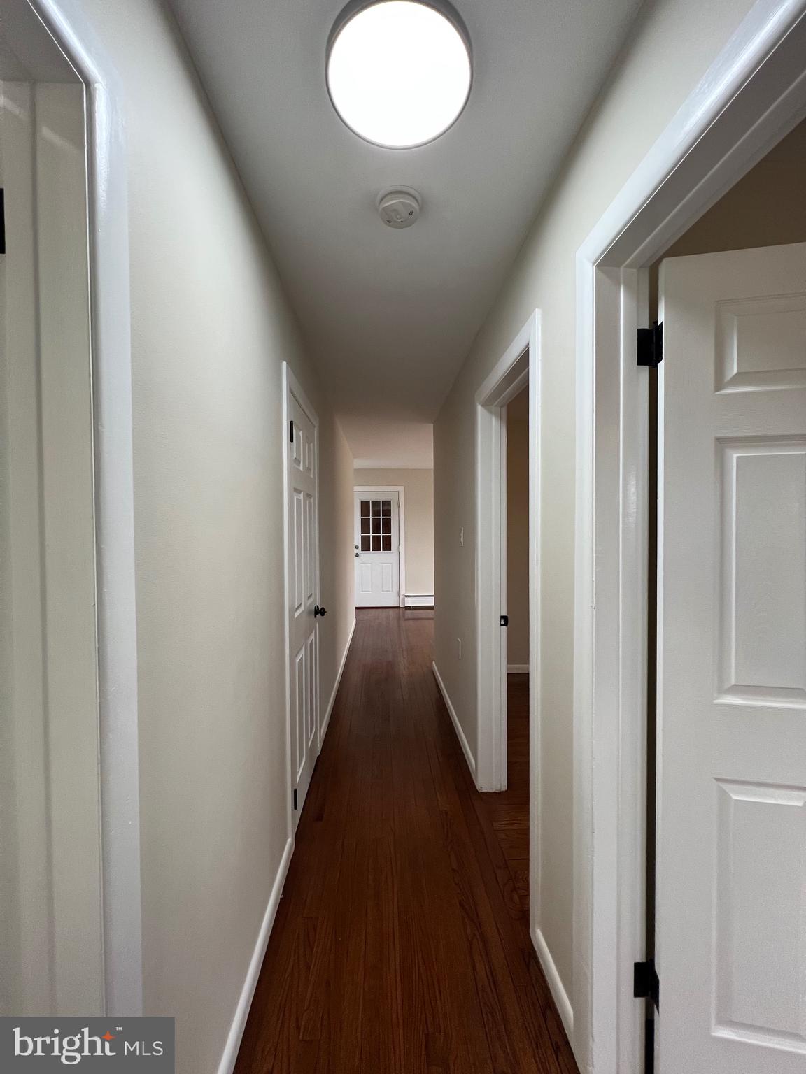 1086 Elk Road Monroeville, NJ 08343 - Photo 14 of 23 a view of a hallway with wooden floor and a bathroom