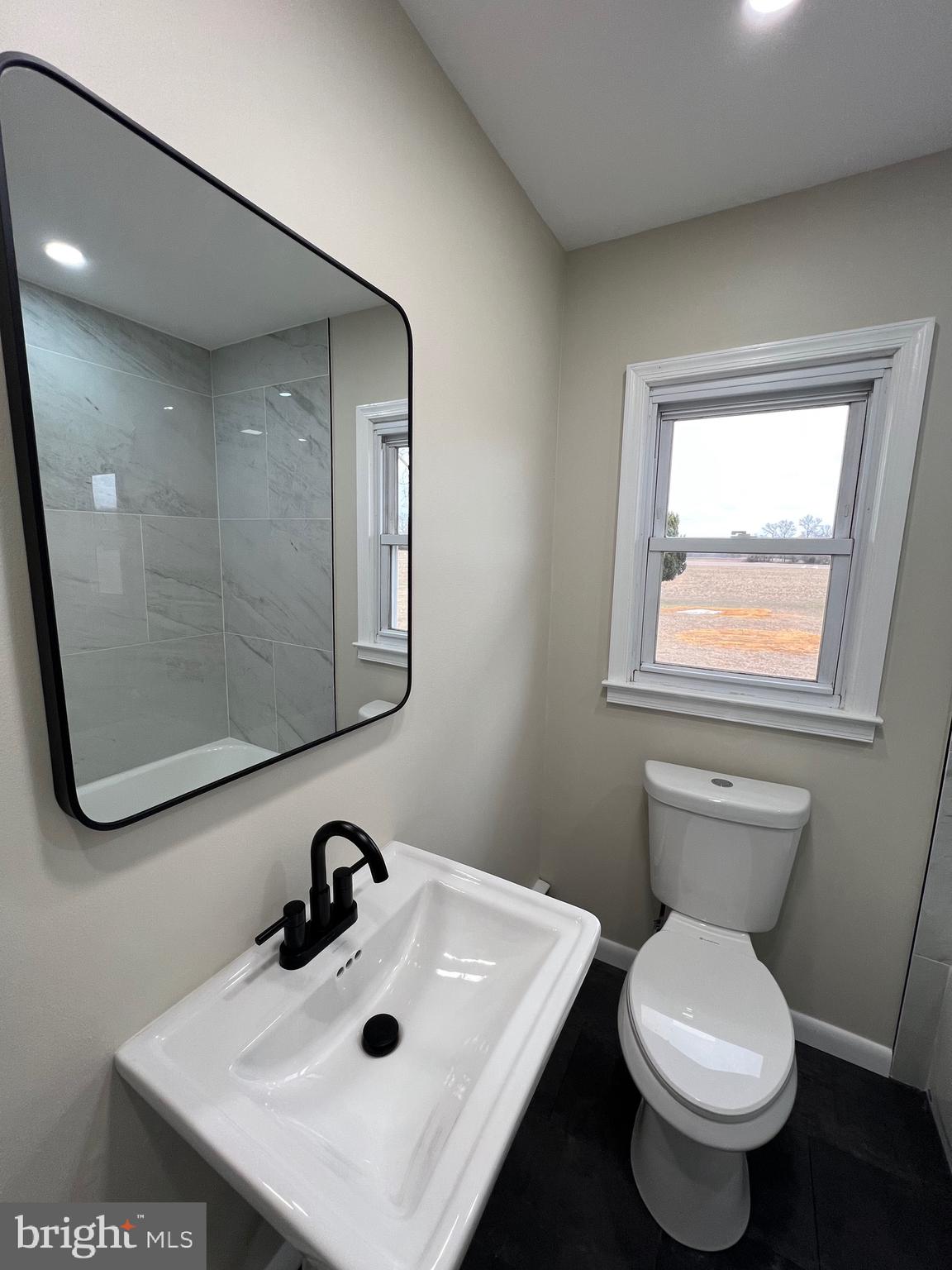 1086 Elk Road Monroeville, NJ 08343 - Photo 16 of 23 a bathroom with a toilet sink and mirror