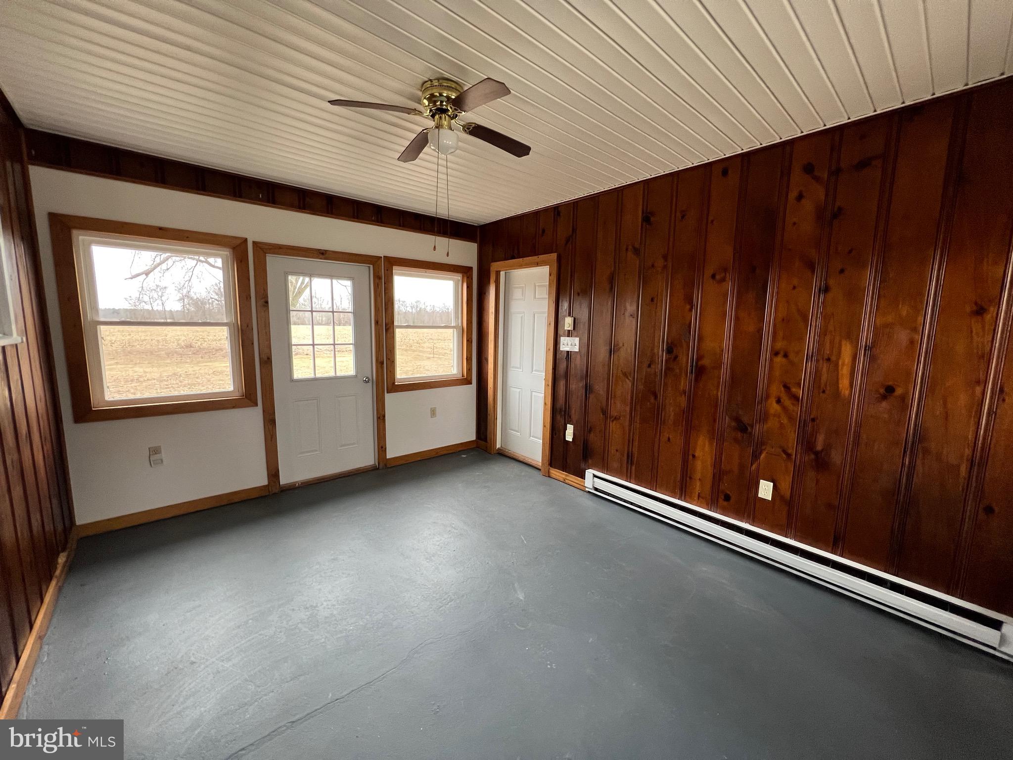 1086 Elk Road Monroeville, NJ 08343 - Photo 17 of 23 an empty room with windows and ceiling fan