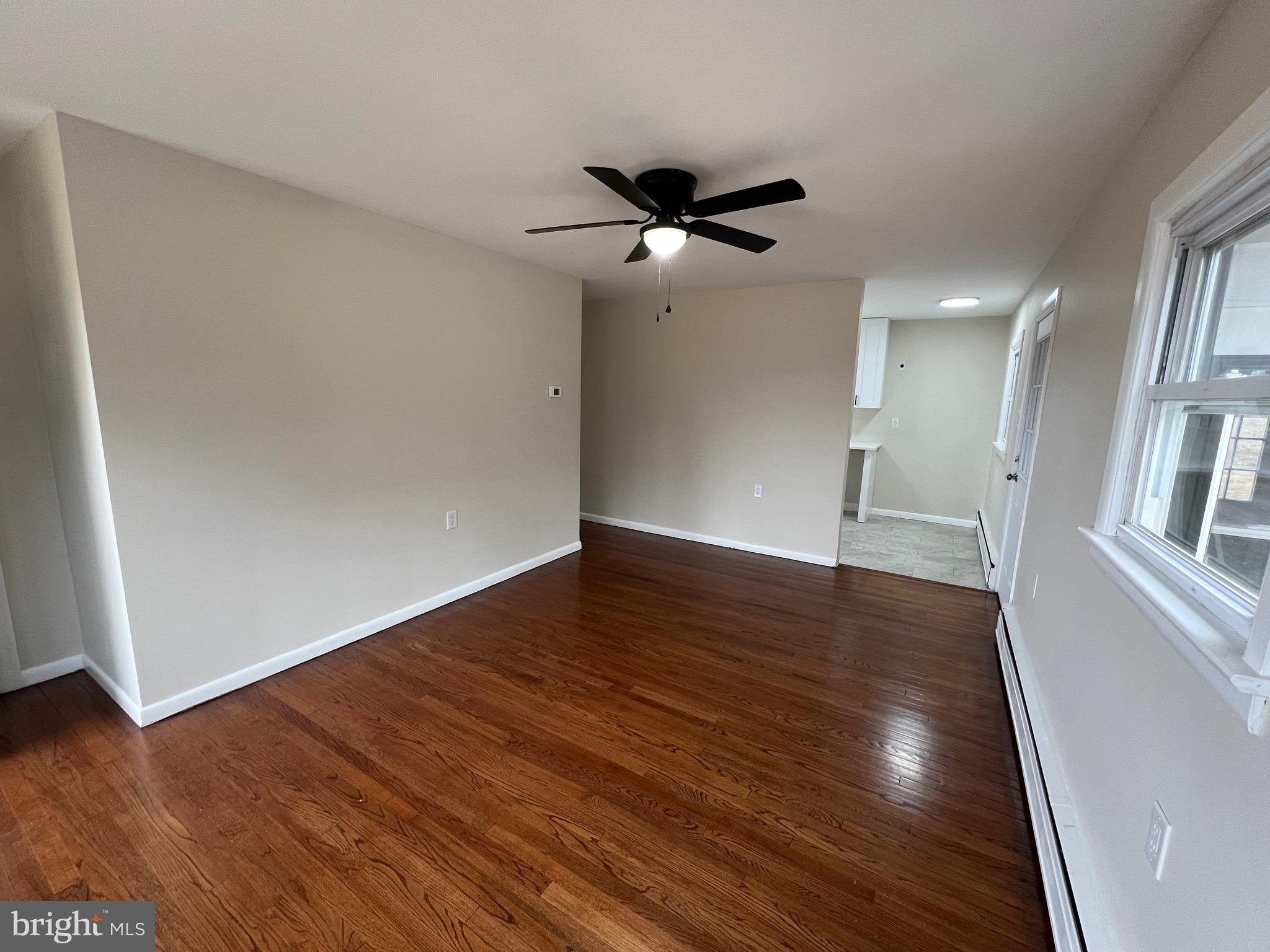 1086 Elk Road Monroeville, NJ 08343 - Photo 4 of 23 wooden floor in an empty room with a window
