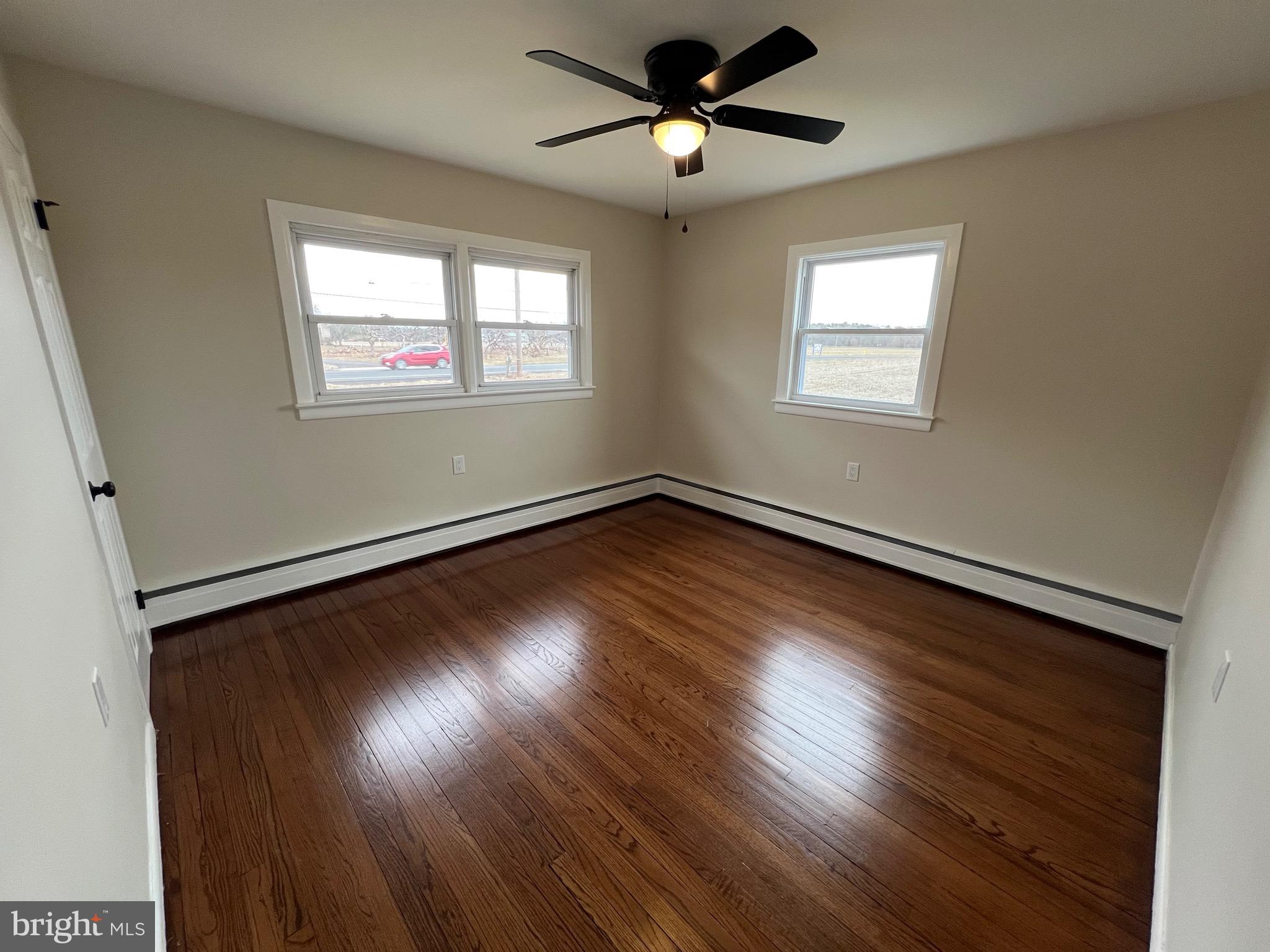 1086 Elk Road Monroeville, NJ 08343 - Photo 10 of 23 a view of empty room with wooden floor and fan