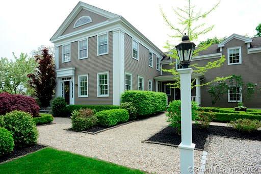 Front entrance and garden crushed stone pathways showcasing boxwood borders, dwarf japanese maple and upright beech tree.
