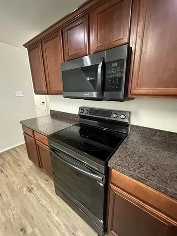 a view of an oven and cabinets