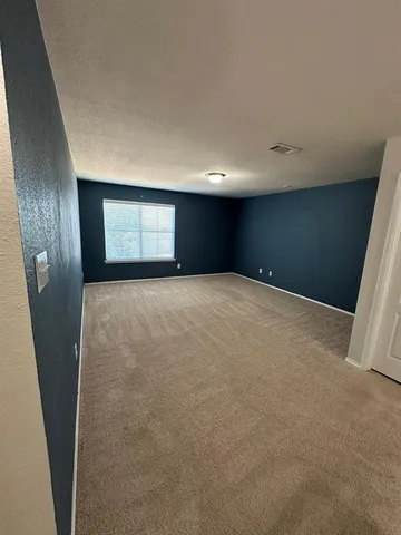 a view of an empty room with a fireplace