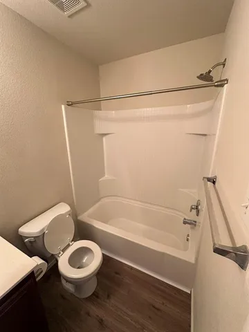a bathroom with a bathtub a sink and a window