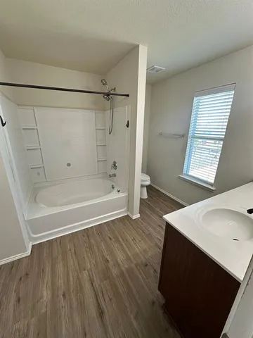 a bathroom with a sink double vanity granite tub shower and a mirror