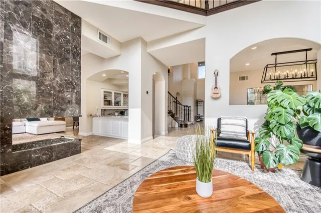 a living room with furniture and a dining table